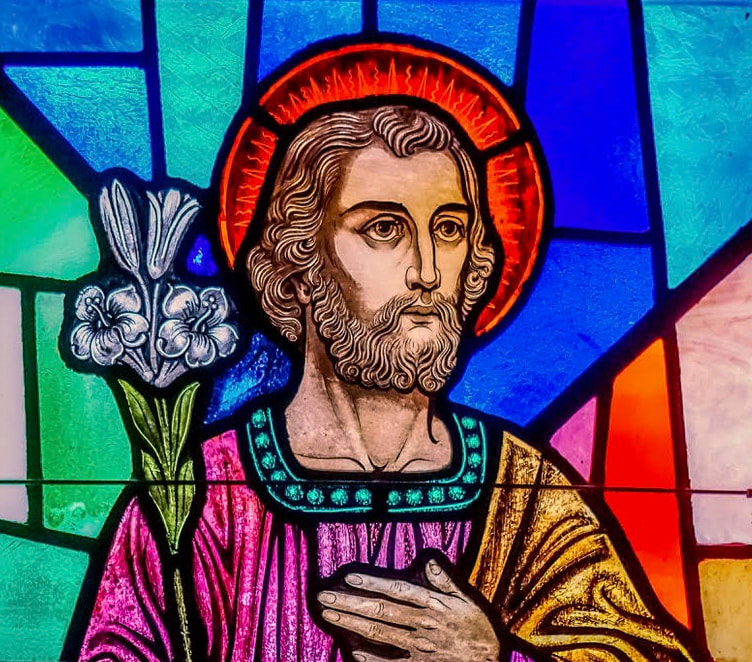 Stained glass window of St. Joseph holding a lily