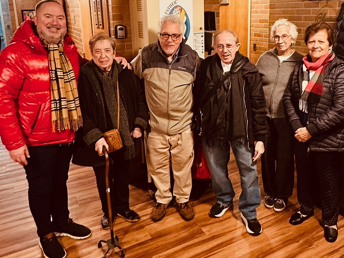 Six parishioners standing together and smiling inside the parish