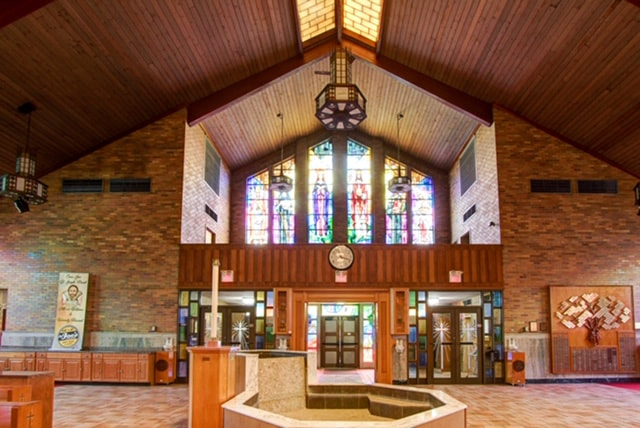 Interior looking back toward the entrance with the baptismal font