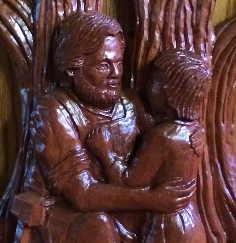 Wood carving of St. Joseph embracing the Christ child