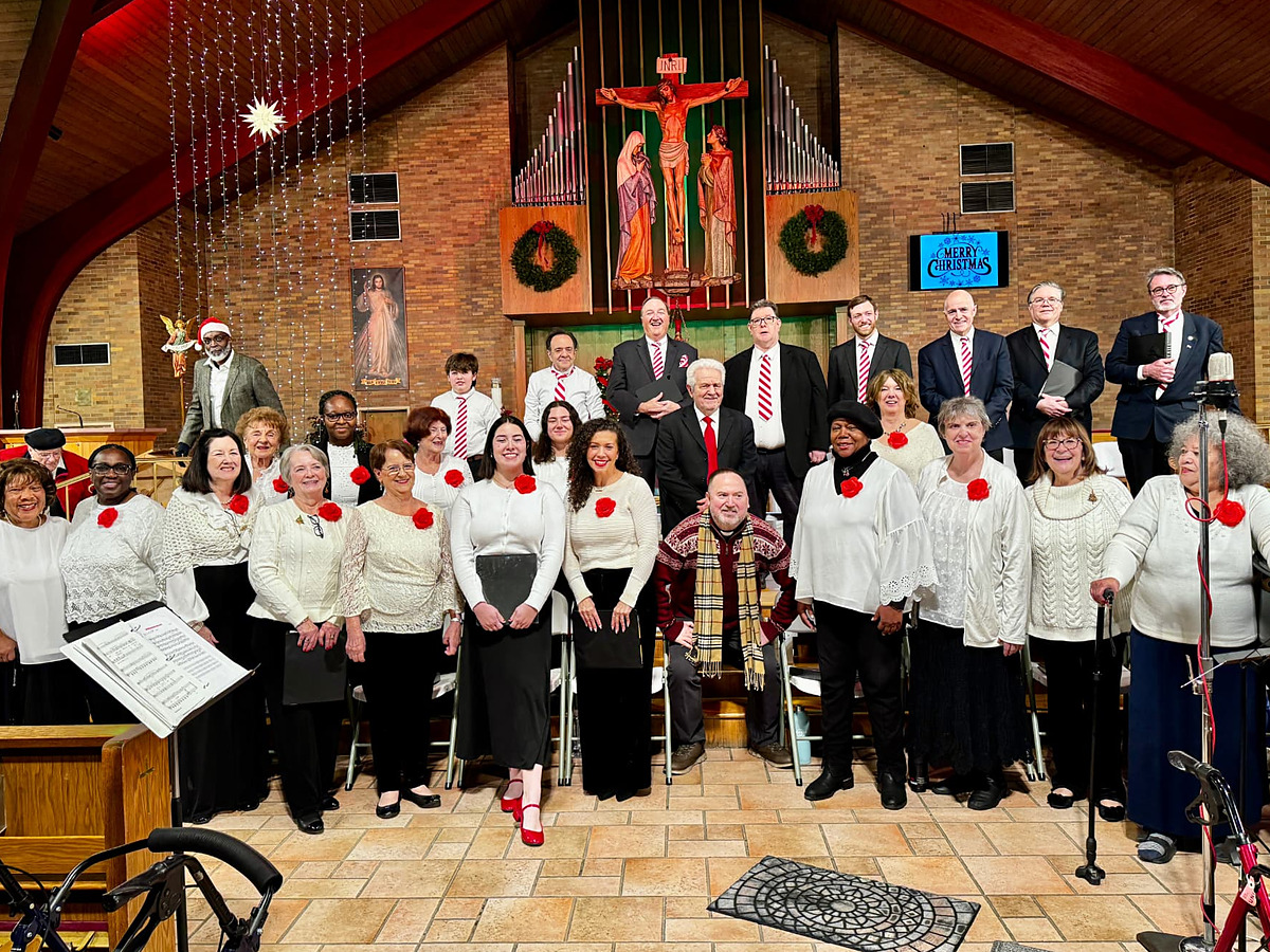 The church choir posed in the sanctuary at Christmas, the organ and crucifix behind them
